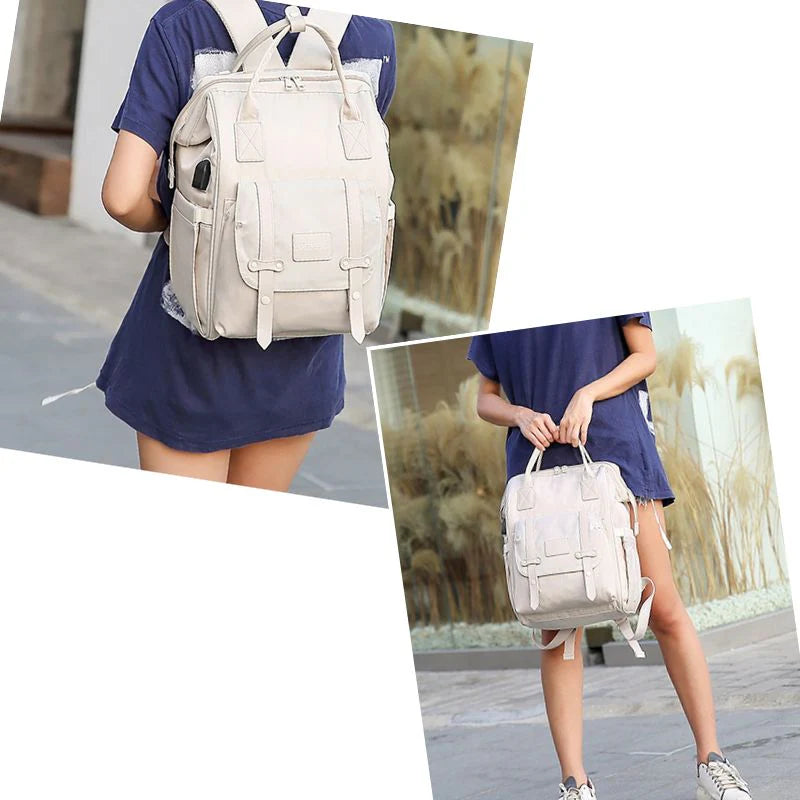 Sac à langer Nora™ porté sur le dos par une maman